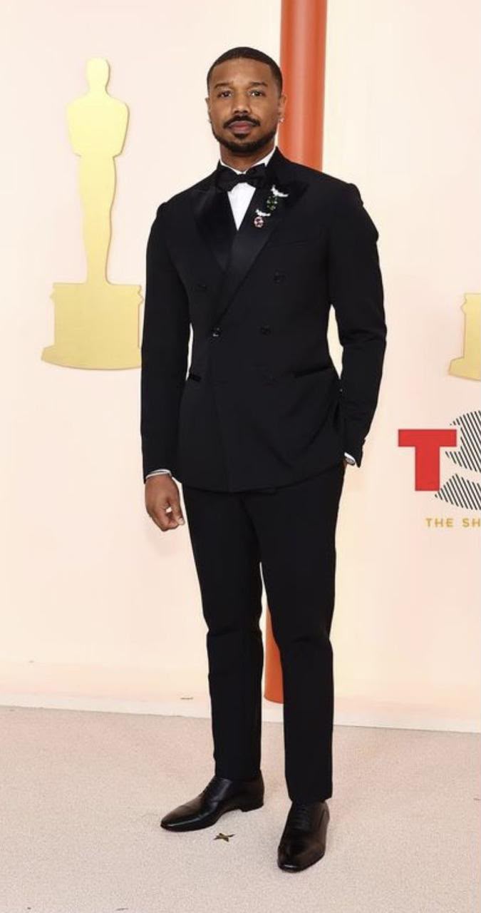 A black double-breasted tuxedo with a white shirt and bow tie